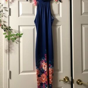 Form fitting. Sleeveless royal blue with flower pattern accent on the bottom
